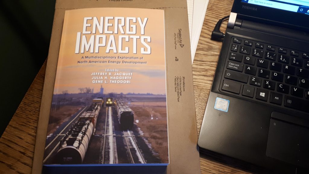The long-awaited Energy Impacts volume on my home office desk.